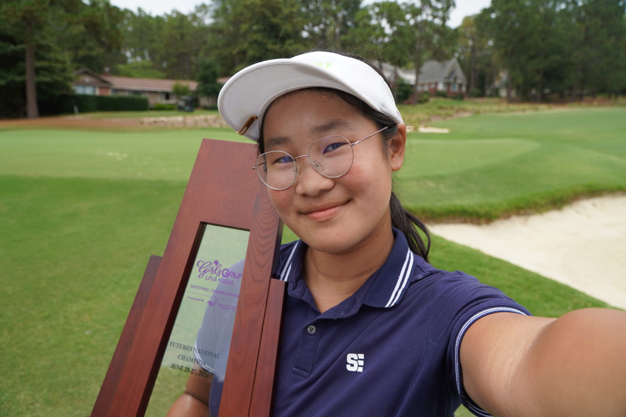 Futures National Champion Anna Wu Posing with Trophy